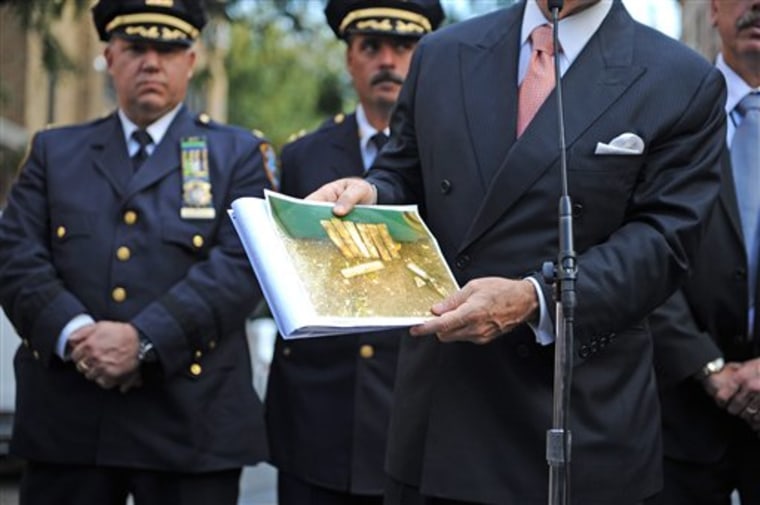  Police Commissioner Raymond Kelly holds a photo of explosives found in New York City Marble Cemetery on Manhattan's Lower East Side on Monday in New York. A caretaker doing gardening work at a historic cemetery dug up a plastic garbage bag containing military-grade explosives last fall and left it at the site, where it remained until a volunteer told authorities about it Monday, setting off a big police response. 